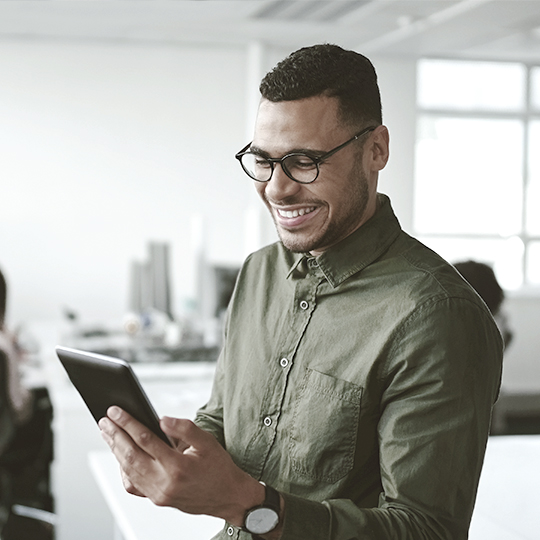 man looking into his tablet