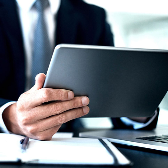 man looking into a tablet