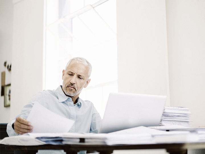 man looking into papers