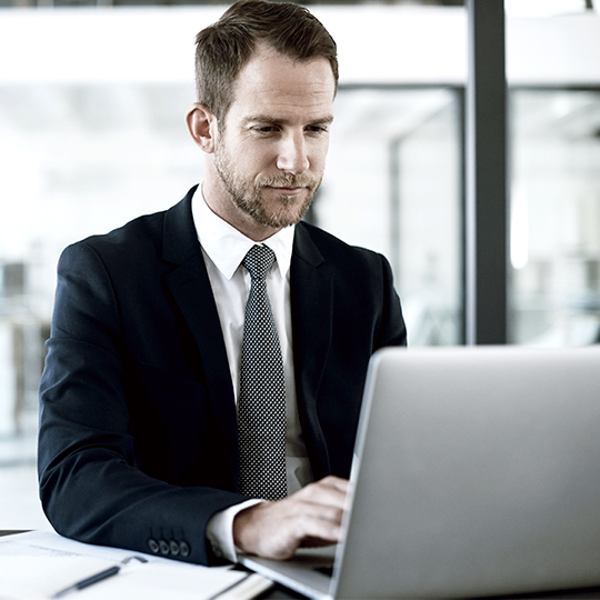 man looking into a screen 