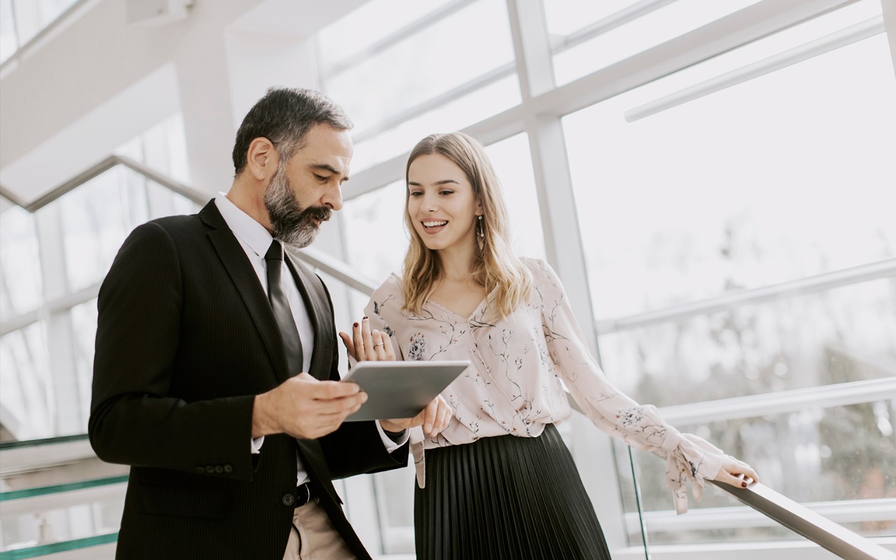 people looking into a tablet