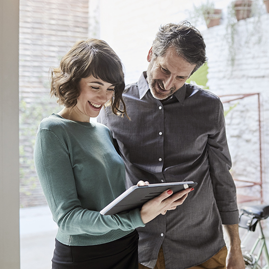 people talking holding a tablet