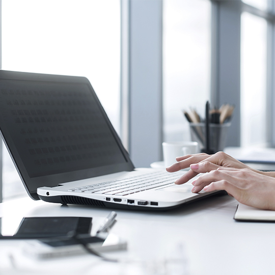 worker typing in a laptop